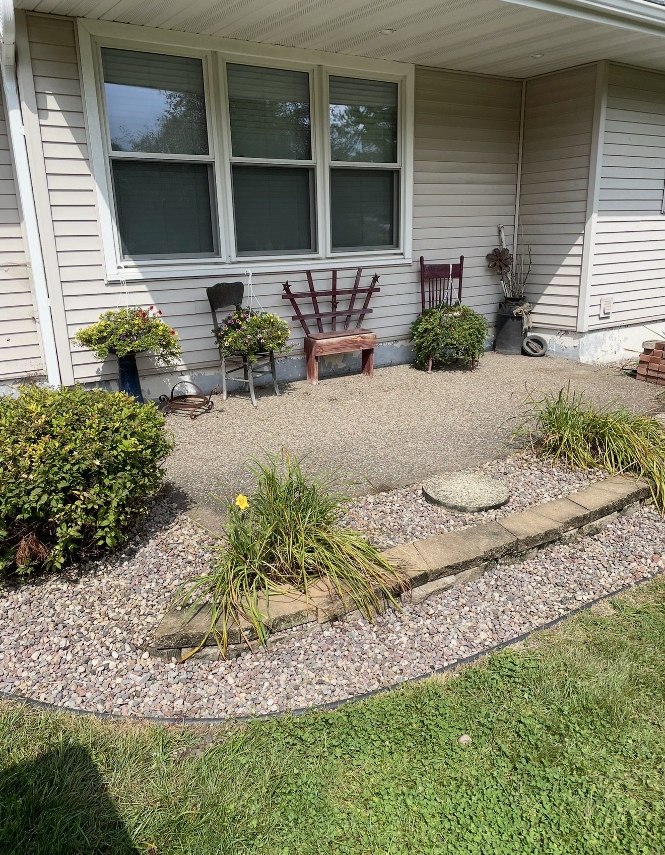 A finished patio and landscaped beds at a Quality Lawn Care client's home