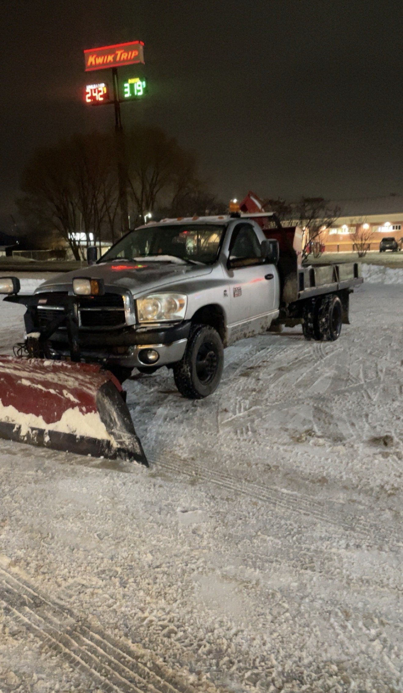 Quality Lawn Care plow truck out on a Wisconsin snow night